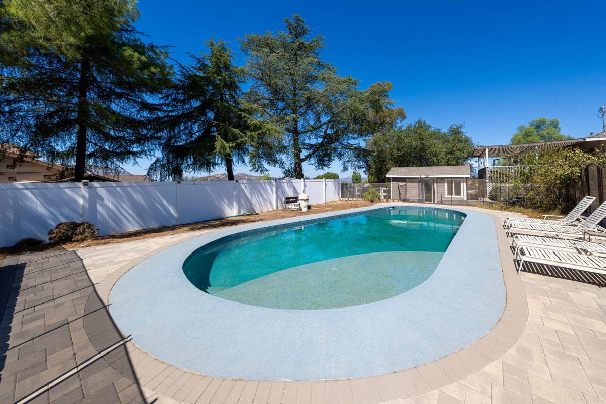 Pool with the pool house and mountain views in the distance